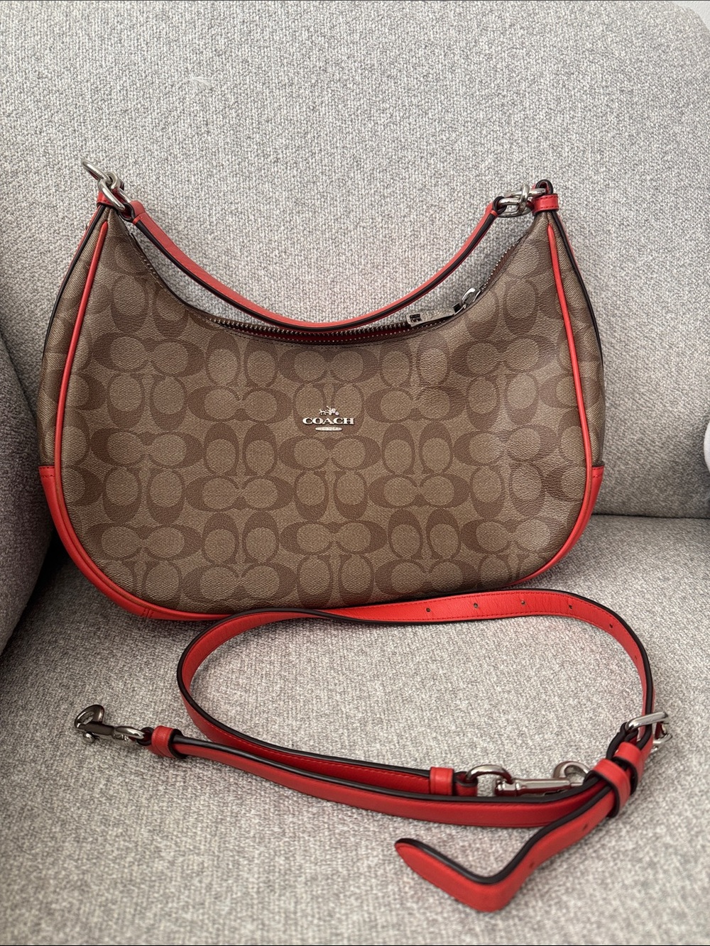 Coach Aria Shoulder bag in signature canvas with bright orange leather trim.